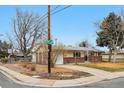 Corner lot house with brick and siding, featuring a driveway and landscaping at 3261 Kassler Pl, Westminster, CO 80031