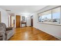 Bright living room features hardwood floors, a large window, and a welcoming atmosphere at 3261 Kassler Pl, Westminster, CO 80031