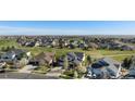 Expansive aerial view of a residential neighborhood with homes overlooking a lush green golf course at 26861 E Clifton Dr, Aurora, CO 80016