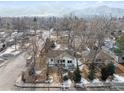 An aerial view of a quaint home with mature trees and mountain views in a quiet neighborhood at 2024 Ford St, Golden, CO 80401