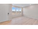 Bright living room with hardwood floors and large windows at 16783 W 94Th Way, Arvada, CO 80007