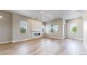 Bright living room with wood floors, modern fireplace, and lots of natural light at 6799 Navajo St, Denver, CO 80221
