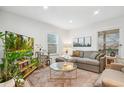 Cozy living area featuring plush seating, natural light, and a decorative rug that complements the space at 6420 W 6Th Ave, Lakewood, CO 80214