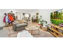 Inviting living room highlighted by comfortable furnishings, eclectic decor, and an abundance of natural light at 6420 W 6Th Ave, Lakewood, CO 80214
