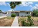 Charming single story home featuring a well-maintained lawn and concrete walkway at 2308 Lima St, Aurora, CO 80010