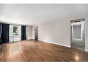 Spacious living room boasting wood floors, fresh neutral paint, and a light and airy feel at 2308 Lima St, Aurora, CO 80010