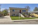 Inviting exterior with well-maintained landscaping and a long driveway at 6488 E 63Rd Pl, Commerce City, CO 80022