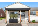 Inviting porch area enhanced with a black awning, decorative address display, and tasteful greenery at 1749 Havana St, Aurora, CO 80010