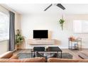 Well-lit living room with modern furniture, sleek floating media console, and stylish gray rug at 1749 Havana St, Aurora, CO 80010
