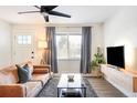 Bright living room with a cozy brown couch, chic black coffee table, and contemporary decor at 1749 Havana St, Aurora, CO 80010