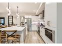 Well-equipped kitchen with white cabinets, an island, stainless steel appliances, and stylish accents at 6058 Beeler Ct, Denver, CO 80238