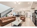 Open-concept living area with modern staircase seamlessly blends living, dining, and kitchen spaces at 6058 Beeler Ct, Denver, CO 80238