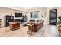 Sophisticated living room featuring hardwood floors, designer furniture, and abundant natural light at 6058 Beeler Ct, Denver, CO 80238