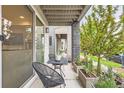 Relax on the porch with a cozy seating area and views of the landscaped front yard and neighborhood at 6058 Beeler Ct, Denver, CO 80238