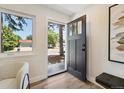 Inviting foyer featuring wood-look floors, a modern door, and a view to the exterior at 2616 W 134Th Cir, Broomfield, CO 80020