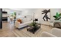 Comfortable living room with hardwood floors, neutral furniture, and modern accents at 2616 W 134Th Cir, Broomfield, CO 80020