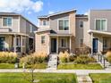 Modern two-story townhome with a front porch and landscaped yard at 12273 Karls Ln, Northglenn, CO 80241