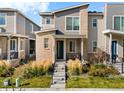 Charming townhouse with a modern design, showcasing a brick facade and well-maintained front yard landscaping at 12273 Karls Ln, Northglenn, CO 80241