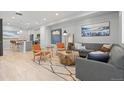 Bright living room featuring modern furniture, stylish decor, and hardwood floors creating a warm and inviting ambiance at 12273 Karls Ln, Northglenn, CO 80241