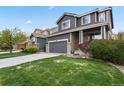 Beautiful two-story home featuring a lush green lawn, gray exterior, and an attached two-car garage at 16164 E Hinsdale Ave, Aurora, CO 80016