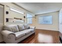 Inviting living room area featuring hardwood floors and a large window, providing ample natural light at 13343 E Louisiana Ave, Aurora, CO 80012