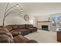 Spacious living room featuring a cozy fireplace and ample seating at 10732 W Florida Ave # B, Lakewood, CO 80232