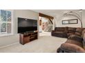 Spacious living room featuring plush carpeting, a large TV, and comfortable seating at 10732 W Florida Ave # B, Lakewood, CO 80232