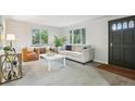 Bright living room with ample seating and natural light from large windows at 5930 W 34Th Ave, Wheat Ridge, CO 80212