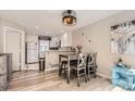 Eat-in kitchen with stainless appliances, hardwood floors, and modern lighting at 2890 W Long Cir # A, Littleton, CO 80120
