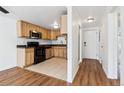 Efficient kitchen design featuring stainless steel appliances and wood cabinets at 969 S Pearl St # 103, Denver, CO 80209