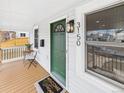 Inviting porch with a green front door, stylish light fixture, and a welcoming doormat at 3150 S Pennsylvania Street, Englewood, CO 80113