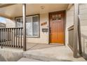 Inviting front door entrance with a porch and railings at 1017 Florence St, Aurora, CO 80010