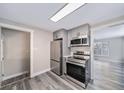 Modern kitchen with stainless steel appliances and gray cabinets at 1017 Florence St, Aurora, CO 80010