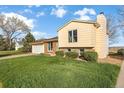 Charming home with a green lawn and tidy landscaping featuring brick accents and neutral siding at 814 Glenwood Dr, Lafayette, CO 80026