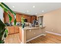 Kitchen island with granite countertops, wood cabinetry, and stainless steel appliances at 4814 Monarch Dr, Firestone, CO 80504