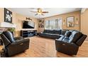 Comfortable living room with hardwood floors, a ceiling fan, and a large leather sectional at 4814 Monarch Dr, Firestone, CO 80504