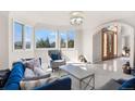 Bright living room featuring a bay window with scenic views and stylish contemporary furniture at 19575 Misty Morning Dr, Monument, CO 80132