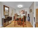 Dining area with glass-top table and four chairs at 3164 S Wheeling Way # 306, Aurora, CO 80014