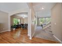 Spacious living room featuring hardwood floors, arched doorways, staircase, and filled with natural light at 10610 Winterflower Way, Parker, CO 80134