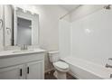 Clean bathroom with white tiled shower/tub combo and vanity at 819 Goodrich Peak St, Erie, CO 80516