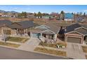 An elevated view of a single-Gathering home with mountain views and an attached two-car garage at 14921 W 70Th Ave, Arvada, CO 80007