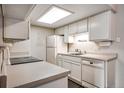 Efficient kitchen with white cabinetry, modern appliances, and ample countertop space for easy meal preparation at 8335 Fairmount Dr # 9-206, Denver, CO 80247
