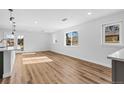 Spacious, bright living room featuring wood floors and large windows for ample natural light at 127 Emerald St, Broomfield, CO 80020