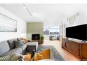 Living room with a comfortable sectional, fireplace, natural light and an entertainment center at 1313 N Williams St # 1003, Denver, CO 80218