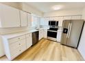 Clean kitchen offers stainless steel appliances, white cabinets, and quartz countertops at 4623 S Lowell Blvd, Denver, CO 80236