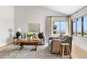 Inviting living room with plush seating, stylish rug, and bright natural light from the window at 6275 Ponderosa Way, Parker, CO 80134