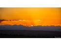 Brilliant Colorado sunset featuring orange skies and majestic mountain silhouettes in the background at 6275 Ponderosa Way, Parker, CO 80134