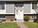 Inviting front entrance with double doors, wreath, and well-maintained landscaping at 6869 Quay St, Arvada, CO 80003