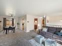 Spacious living room with neutral carpet, comfortable sofa, and dining area at 6869 Quay St, Arvada, CO 80003