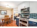 Bright kitchen featuring stainless steel appliances, blue cabinetry, and hardwood floors at 8314 S Everett Way # B, Littleton, CO 80128